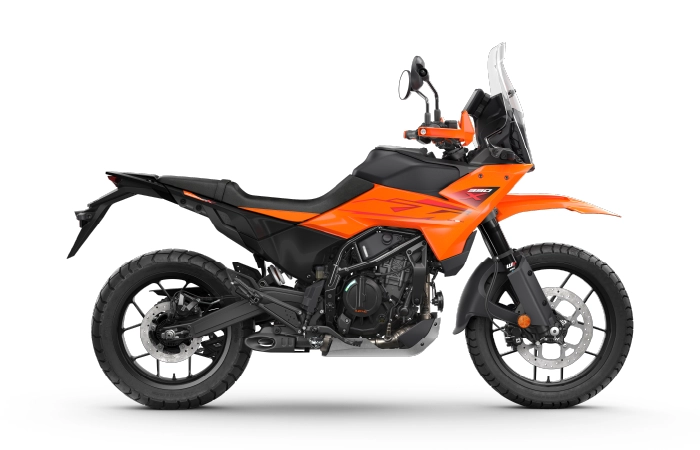 Side profile of 2025 KTM 390 Adventure X in Electronic Orange, showing its sharp design and alloy wheels